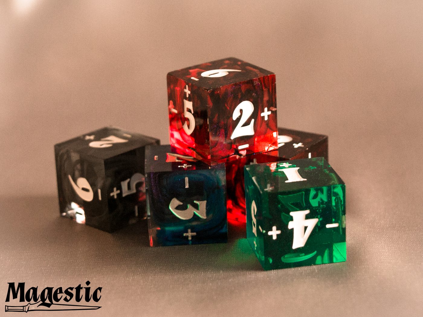 Set of translucent Magestic resin spindown D6 dice in red, green, and black